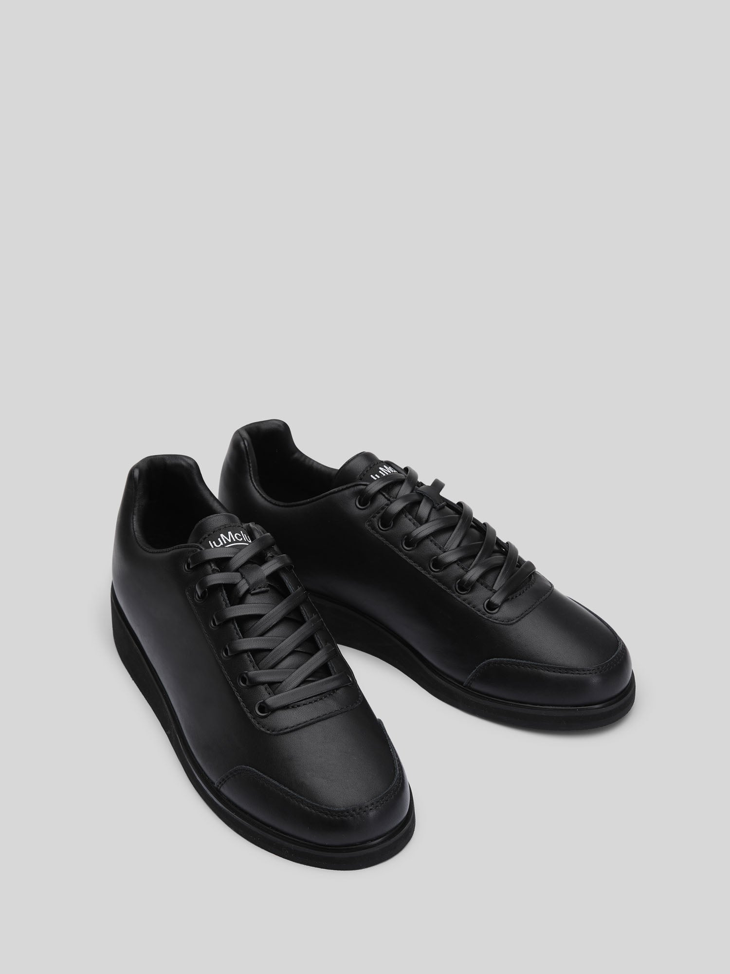 JuMclu Black Leather Luxury Fashion Portal Sneaker — left‑foot promotional prototype, premium full‑grain leather, rare deadstock exclusive edition, dressy high‑end trainers for luxury streetwear shoppers. JuMclu Portal Prototype black leather luxury fashion sneaker, left‑foot promotional edition, crafted in premium full‑grain leather with rare deadstock detailing, exclusive dressy silhouette, discount‑release trainers engineered for elevated style and high‑end streetwear appeal.